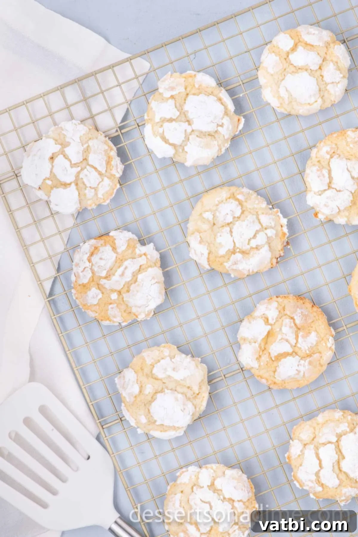 Freshly baked Ooey Gooey Butter Cookies cooling on a wire rack.