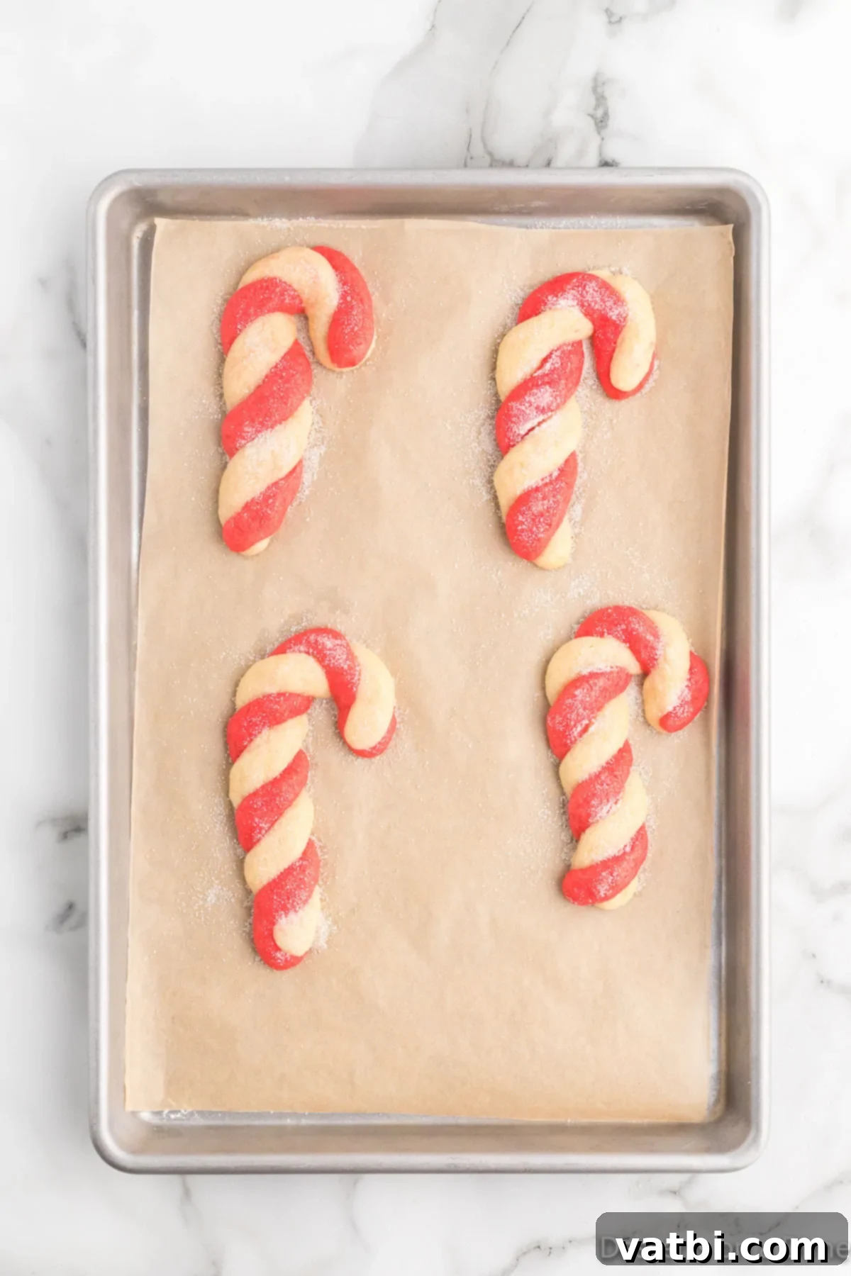 Twisted Peppermint Delights 11 Cookies topped with sparkling sugar and cooling on baking sheet.