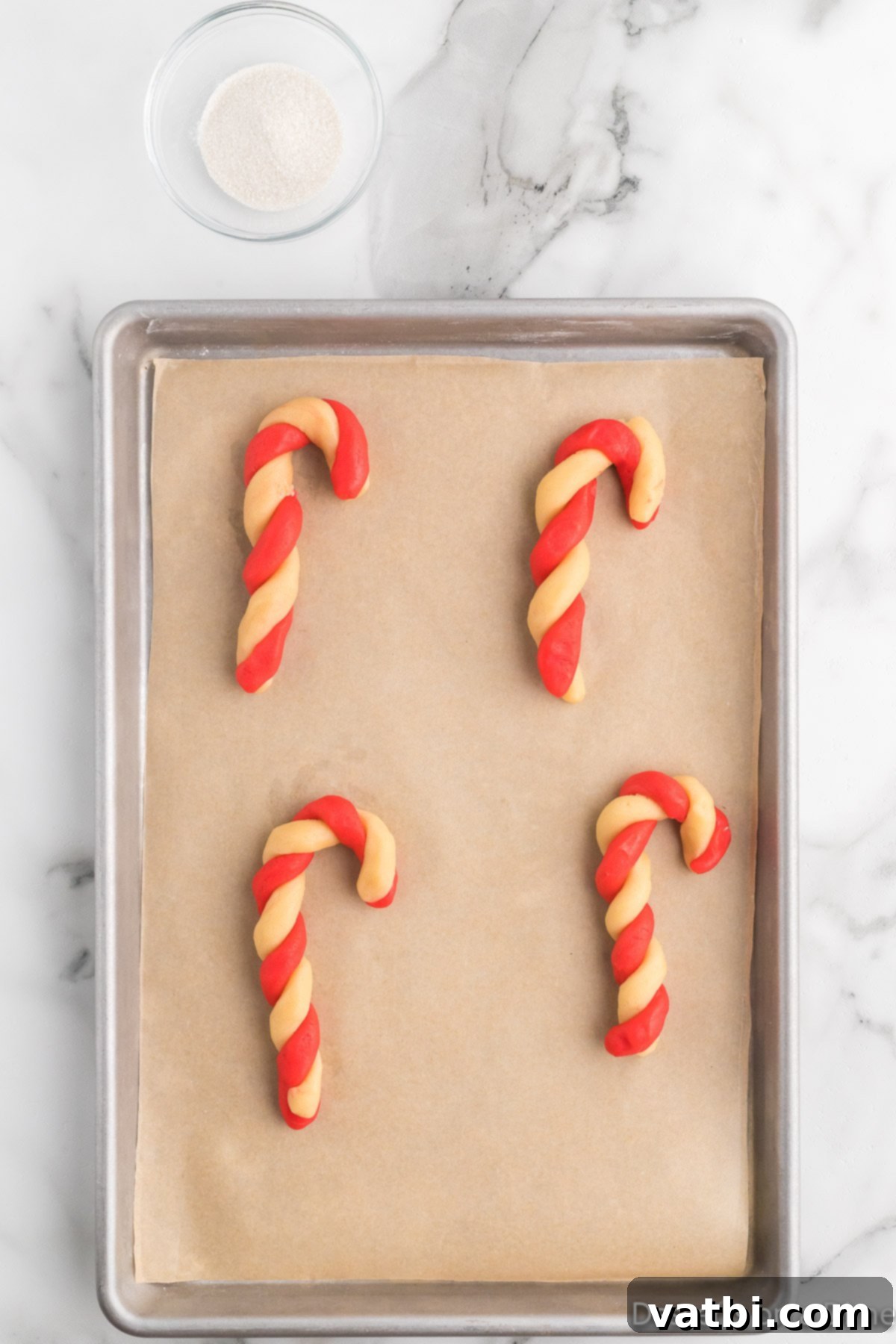 Twisted Peppermint Delights 10 Candy canes twisted together on baking sheet.