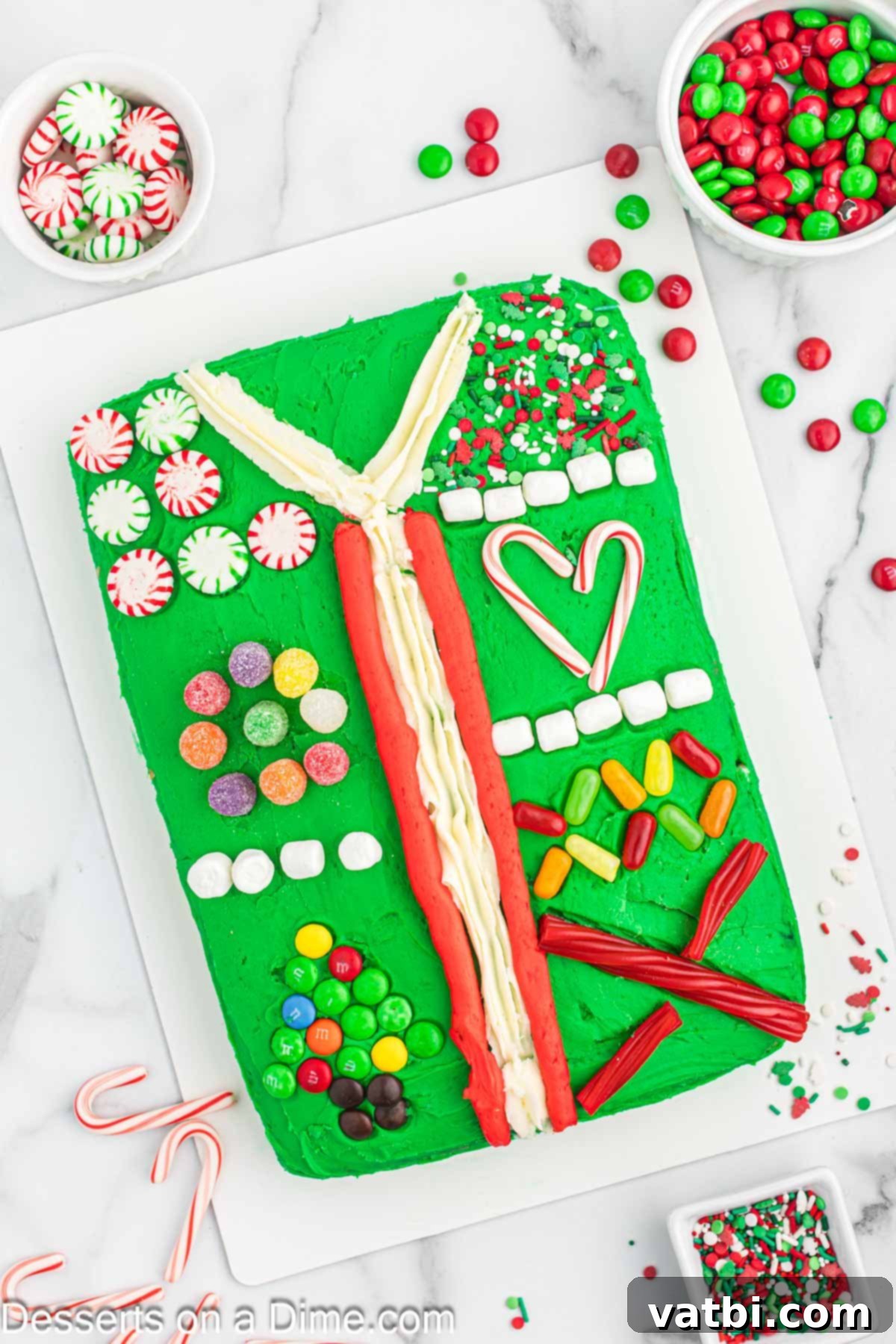 Beautifully decorated Ugly Sweater Cake on a festive platter, showcasing colorful frosting and candy decorations, perfect for holiday parties.