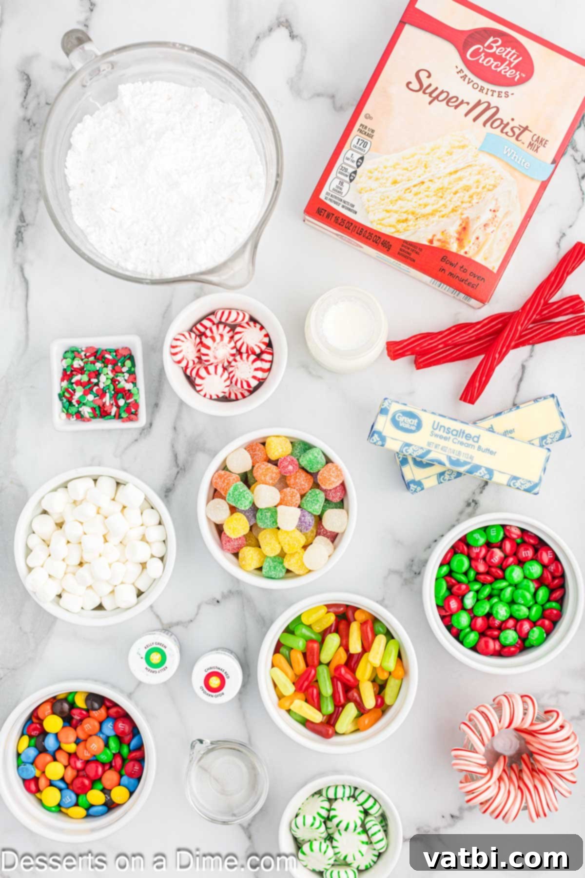 Collection of Ugly Sweater Cake ingredients including cake mix, various candies, and frosting components laid out on a surface.