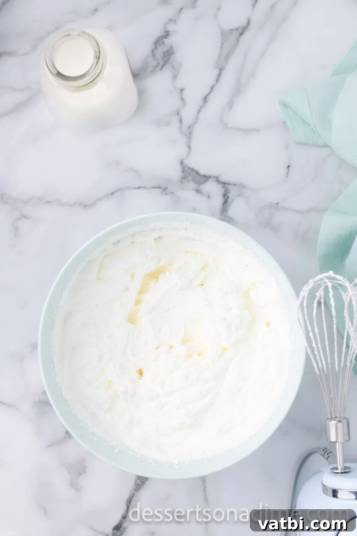 Crimson Craving 7 Separate chilled bowl with heavy whipping cream being whipped to stiff peaks.