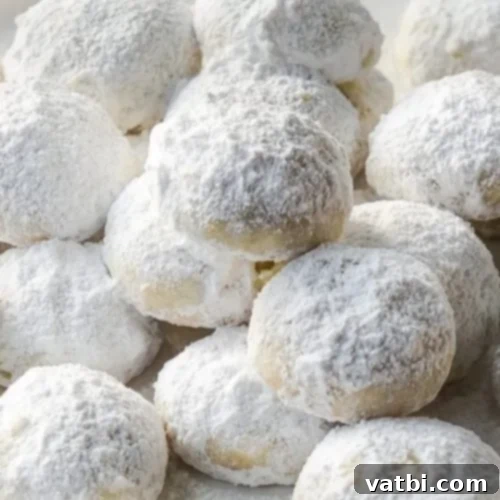 Coconut-Lime Mexican Wedding Cookies, a tropical twist on the classic, dusted with powdered sugar.
