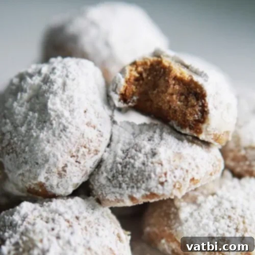 A plate of Galletas de Nuez, crunchy Mexican walnut cookies, similar to Mexican Wedding Cookies, with a dusting of powdered sugar.