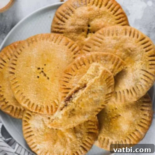 Golden-brown Coyotas, flat and filled Mexican cookies from Sonora, showcasing their decadent filling.