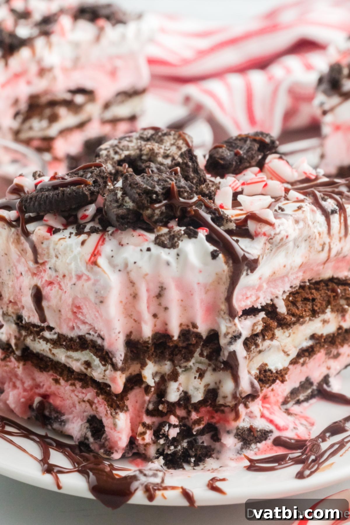 Festive Christmas Ice Cream Cake 12 Square of ice cream cake on a plate with toppings.