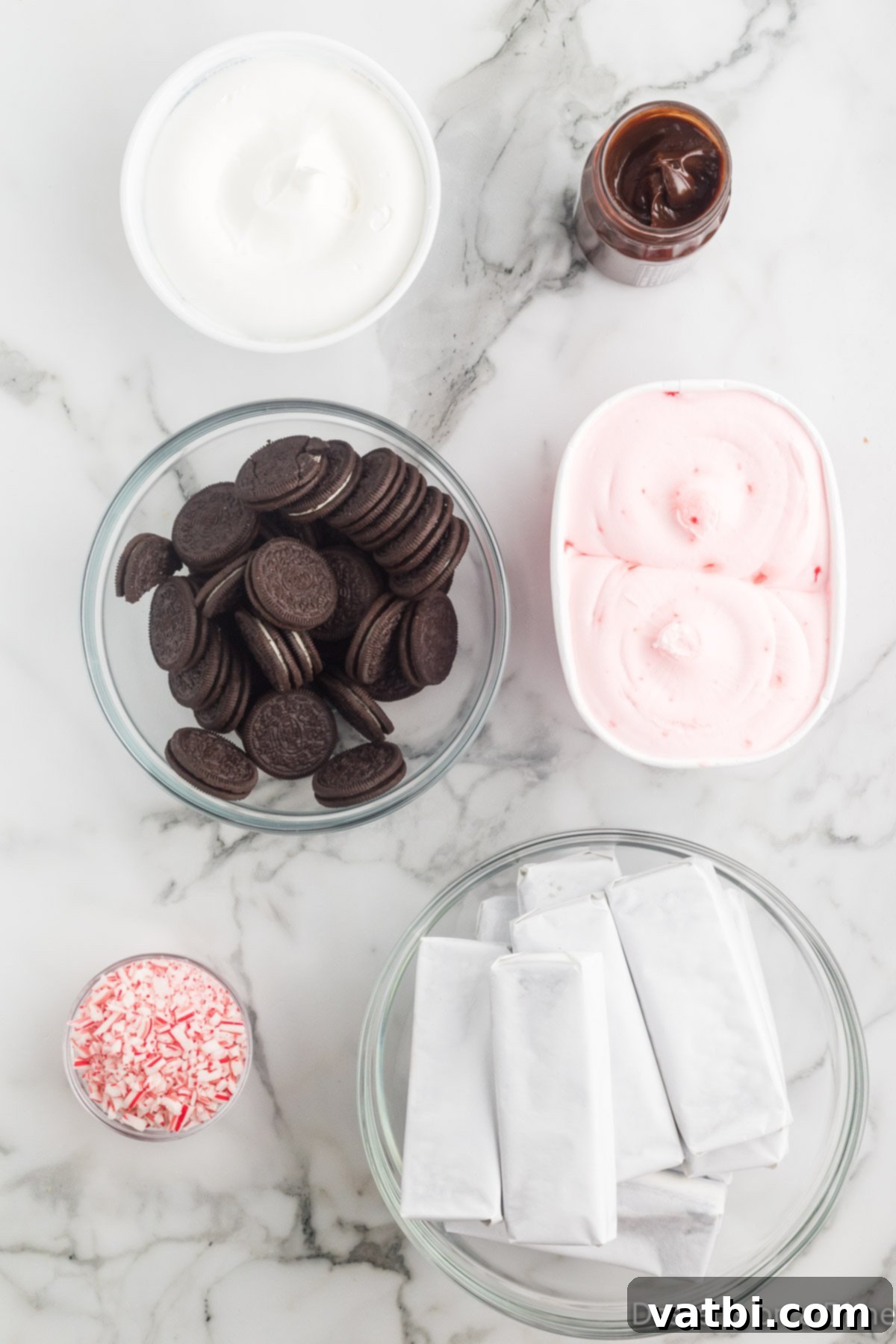 Festive Christmas Ice Cream Cake 3 Ingredients for ice cream cake- peppermint ice cream, oreo cookies, ice cream sandwiches, candy canes.