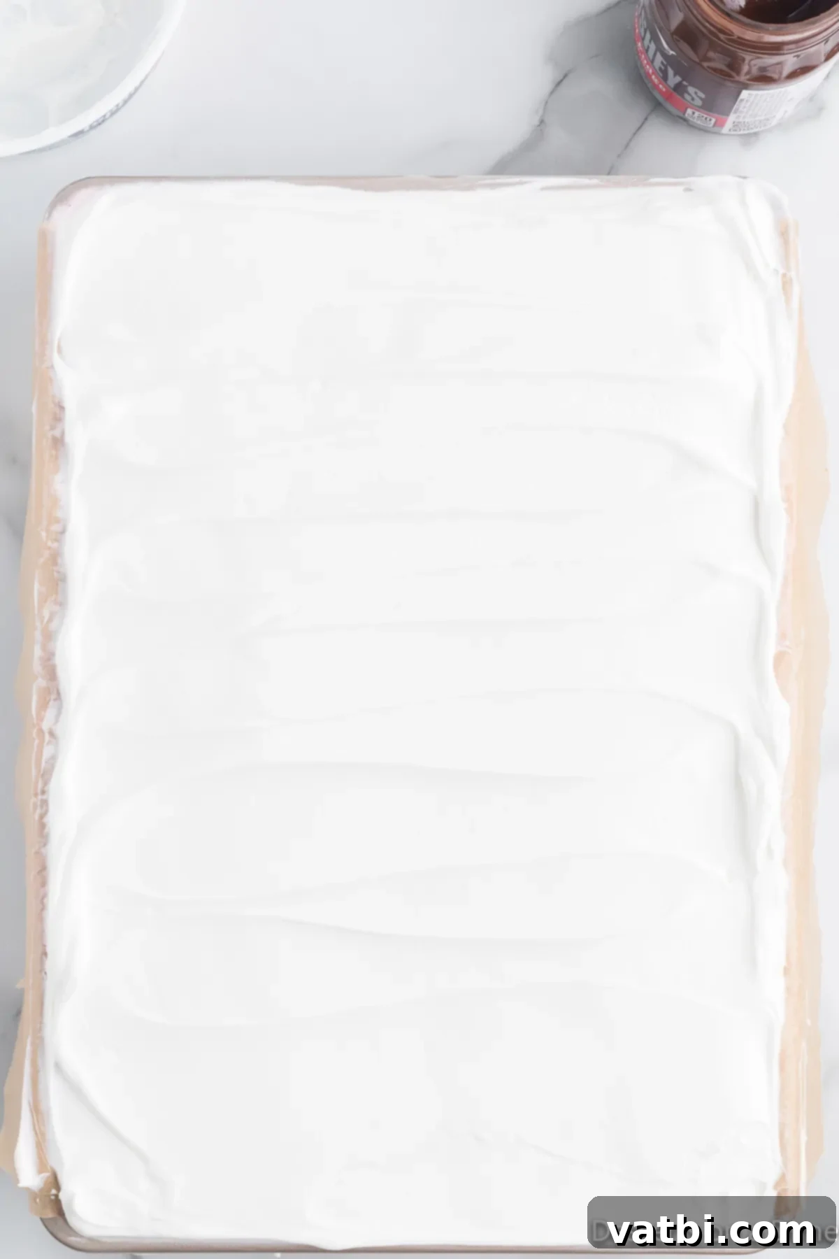 Festive Christmas Ice Cream Cake 10 Whipped cream spread out on dish.