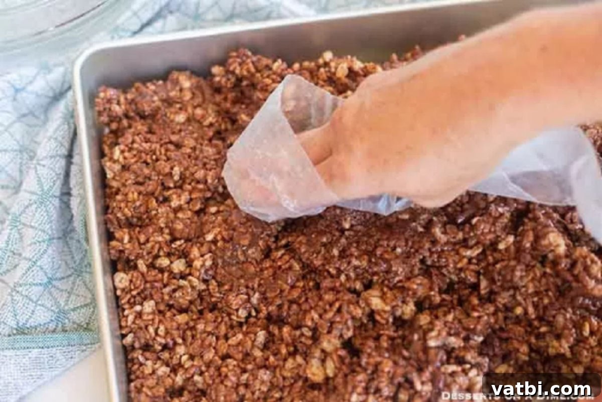 Decadent Chocolate Krispie Squares 5 The chocolate Rice Krispie mixture evenly pressed into a baking dish, ready for cooling.