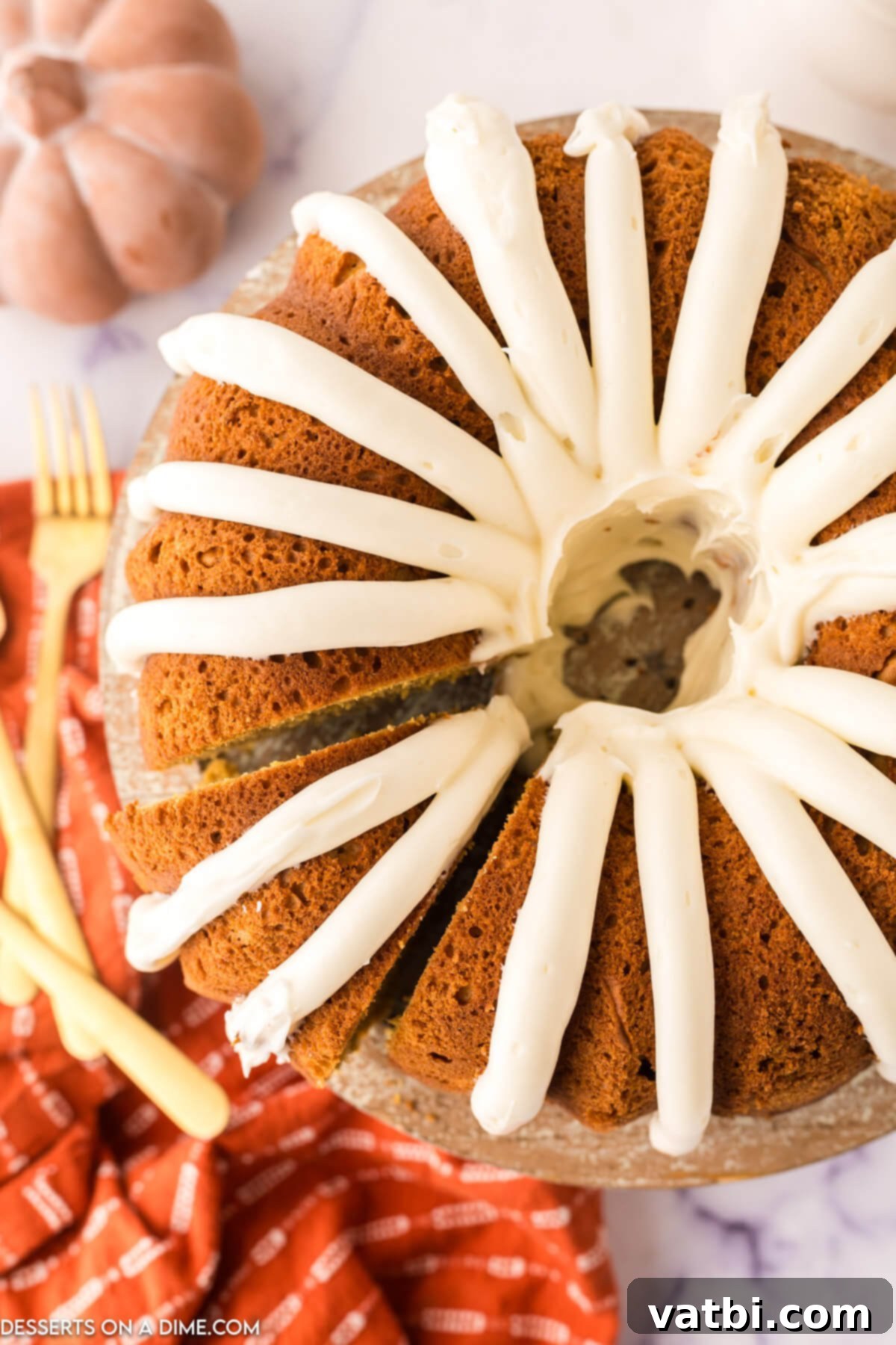 Golden Spiced Pumpkin Bundt 13 Bundt Cake topped with frosting.