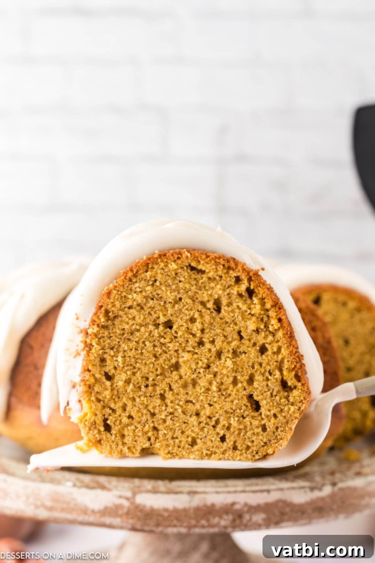 Golden Spiced Pumpkin Bundt 14 Pumpkin Bundt Cake being sliced.
