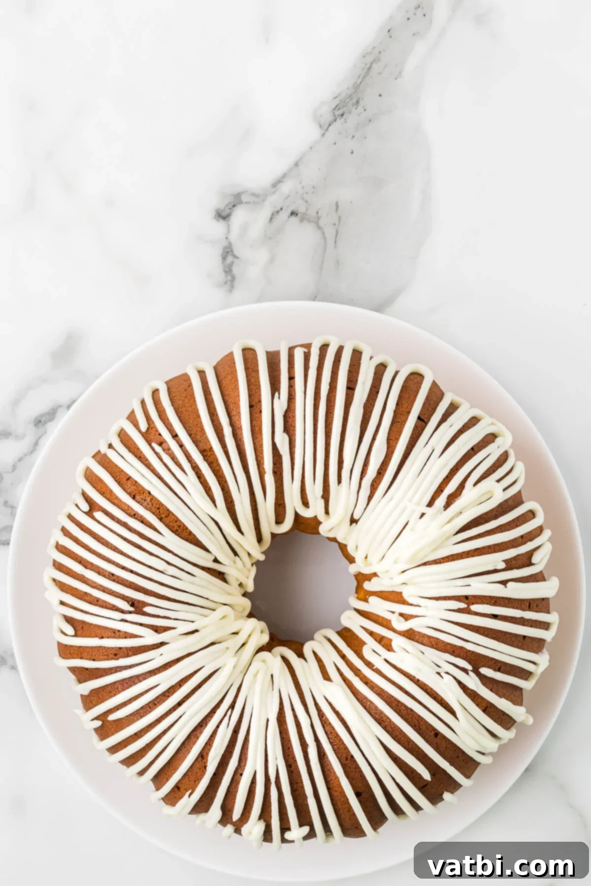 Golden Spiced Pumpkin Bundt 10 Icing piped on to cooled Pumpkin Cake.