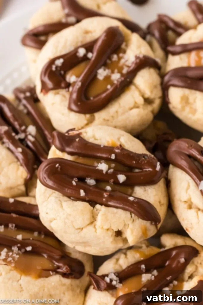 The best Twix Thumbprint Cookies arranged together on the counter, showcasing their caramel, chocolate, and sea salt topping.