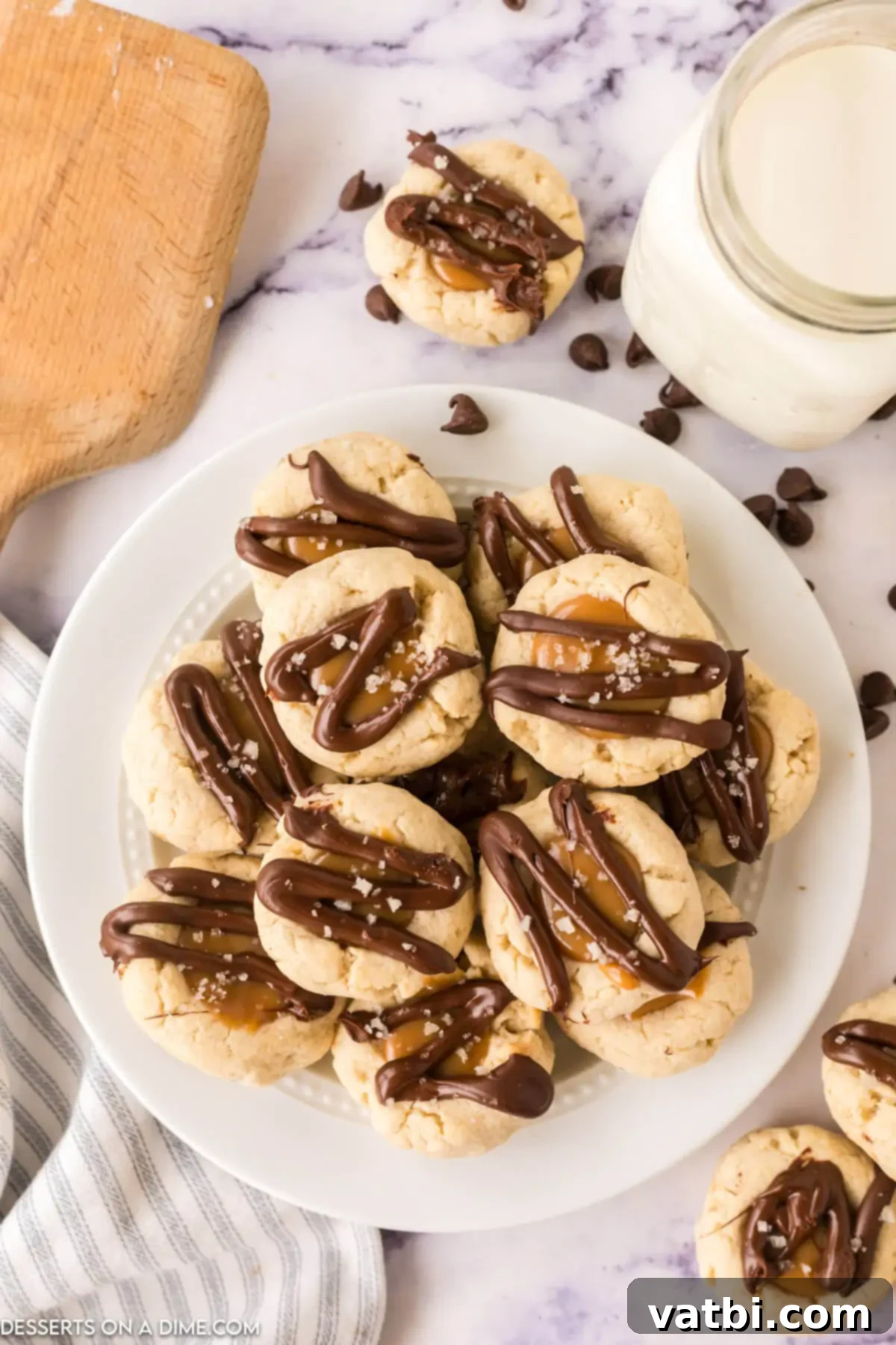 A beautiful platter of finished Twix Thumbprint Cookies, showcasing their tempting layers of shortbread, caramel, chocolate, and sea salt, ready to be enjoyed.