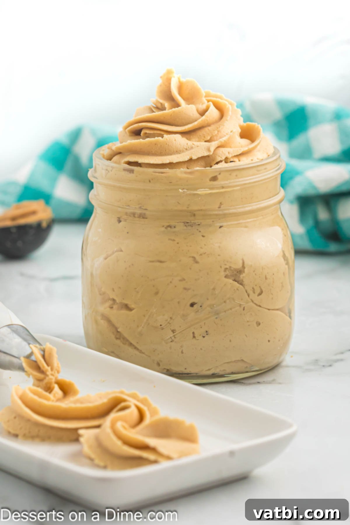 Decadent Peanut Butter Frosting 2 Creamy peanut butter frosting in a jar, ready to be used on desserts.