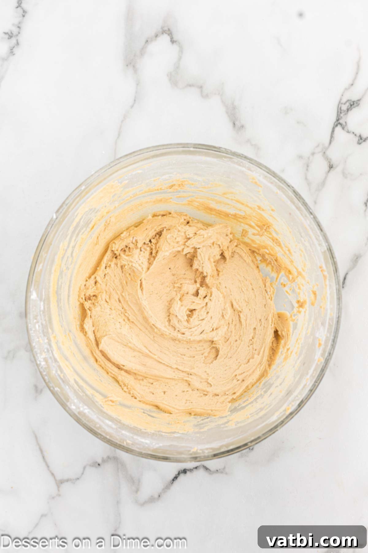 Decadent Peanut Butter Frosting 6 Fully combined and fluffy peanut butter frosting in a mixing bowl, ready for use.