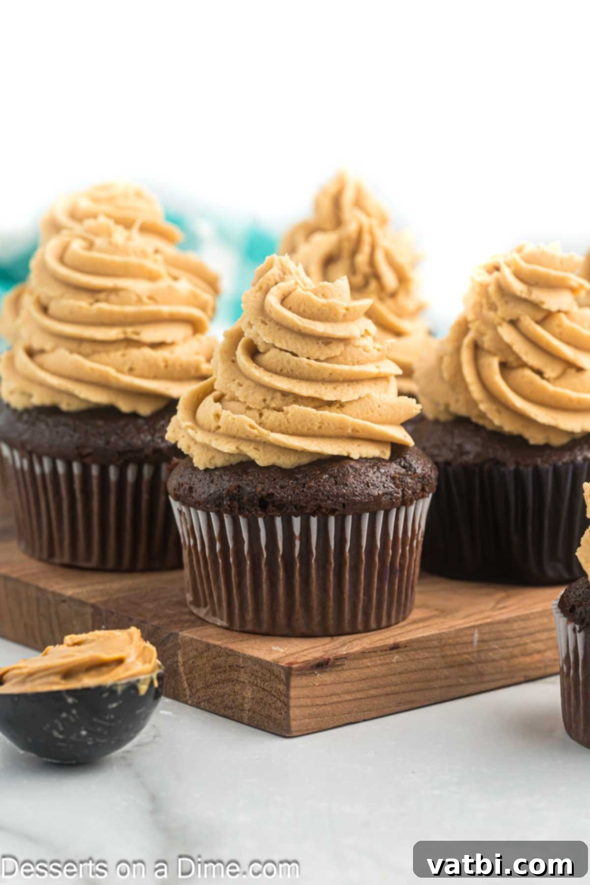 Decadent Peanut Butter Frosting 7 Cupcakes beautifully frosted with peanut butter frosting and topped with decorative sprinkles.