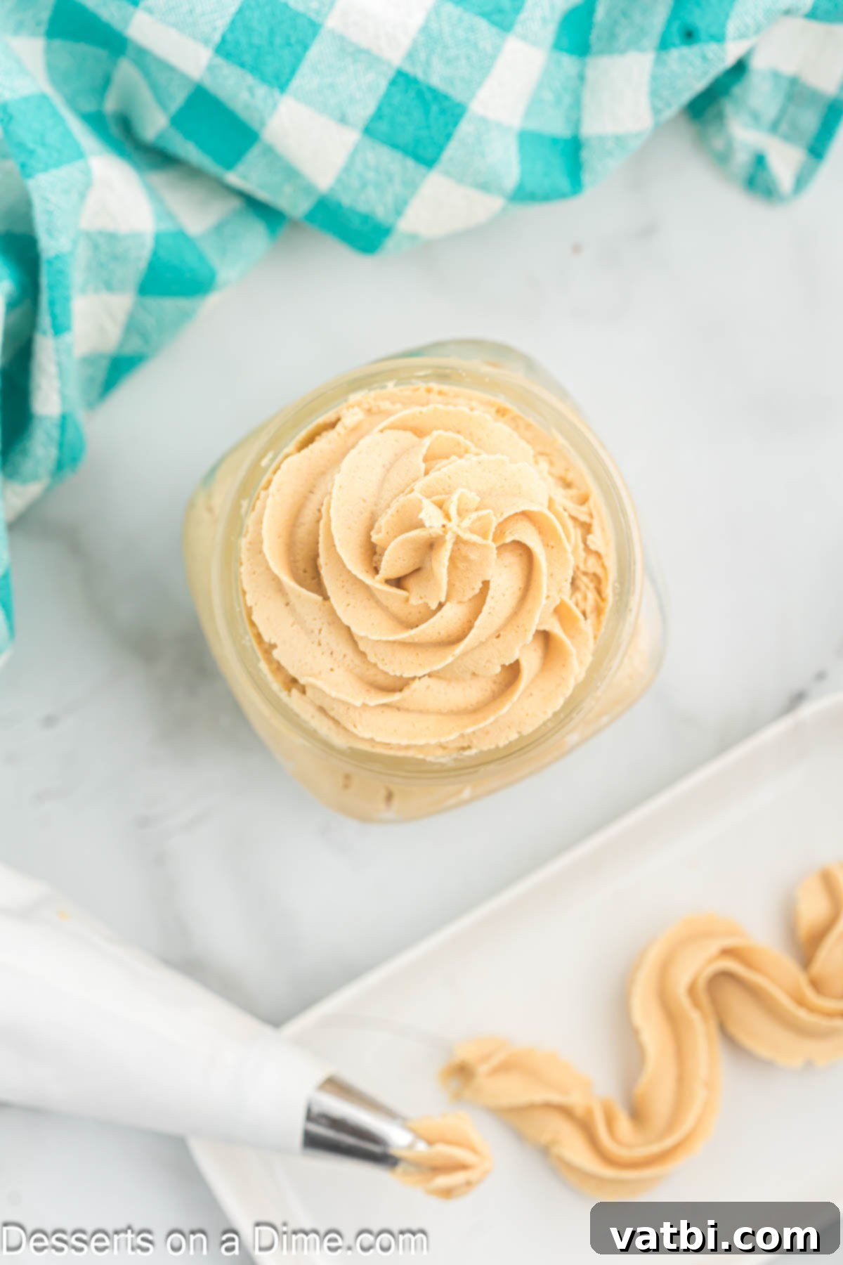 Decadent Peanut Butter Frosting 9 Freshly made peanut butter frosting in a clear glass jar, ready to be used or stored.
