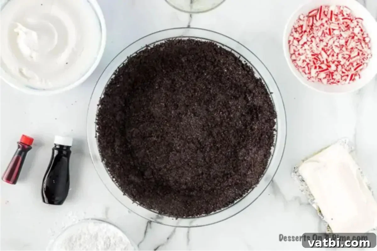 Simple Swirl Candy Cane Pie 2 Crushed Oreo cookies forming the pie crust in a pie plate.