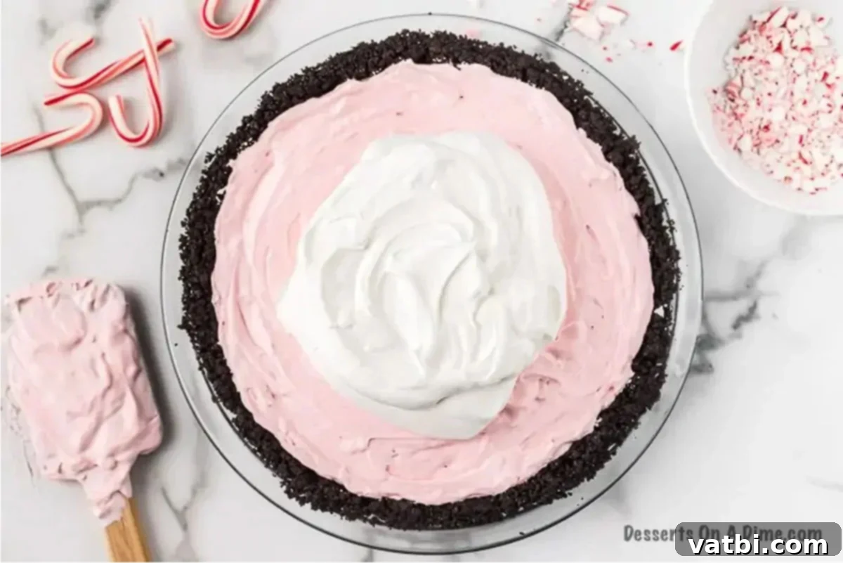 Simple Swirl Candy Cane Pie 3 Creamy peppermint pie filling spooned into the Oreo pie crust.