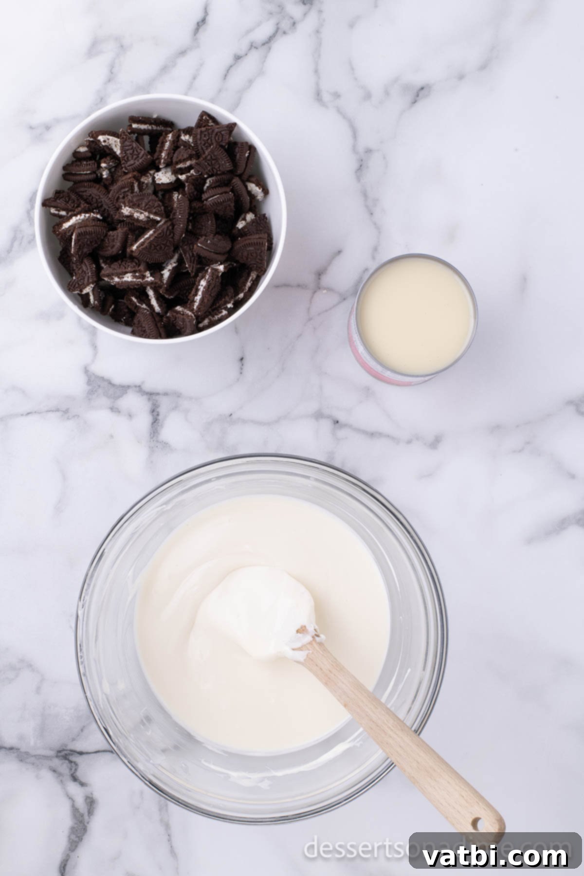 Easy 3-Ingredient Oreo Fudge 2 Bowl with melted white chocolate chips.
