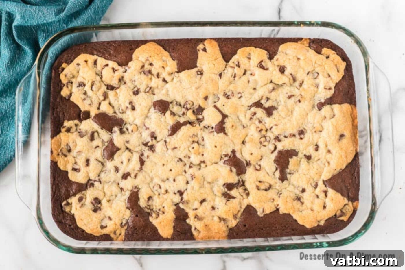 Baked brookie bars cooling in the baking dish after being removed from the oven.