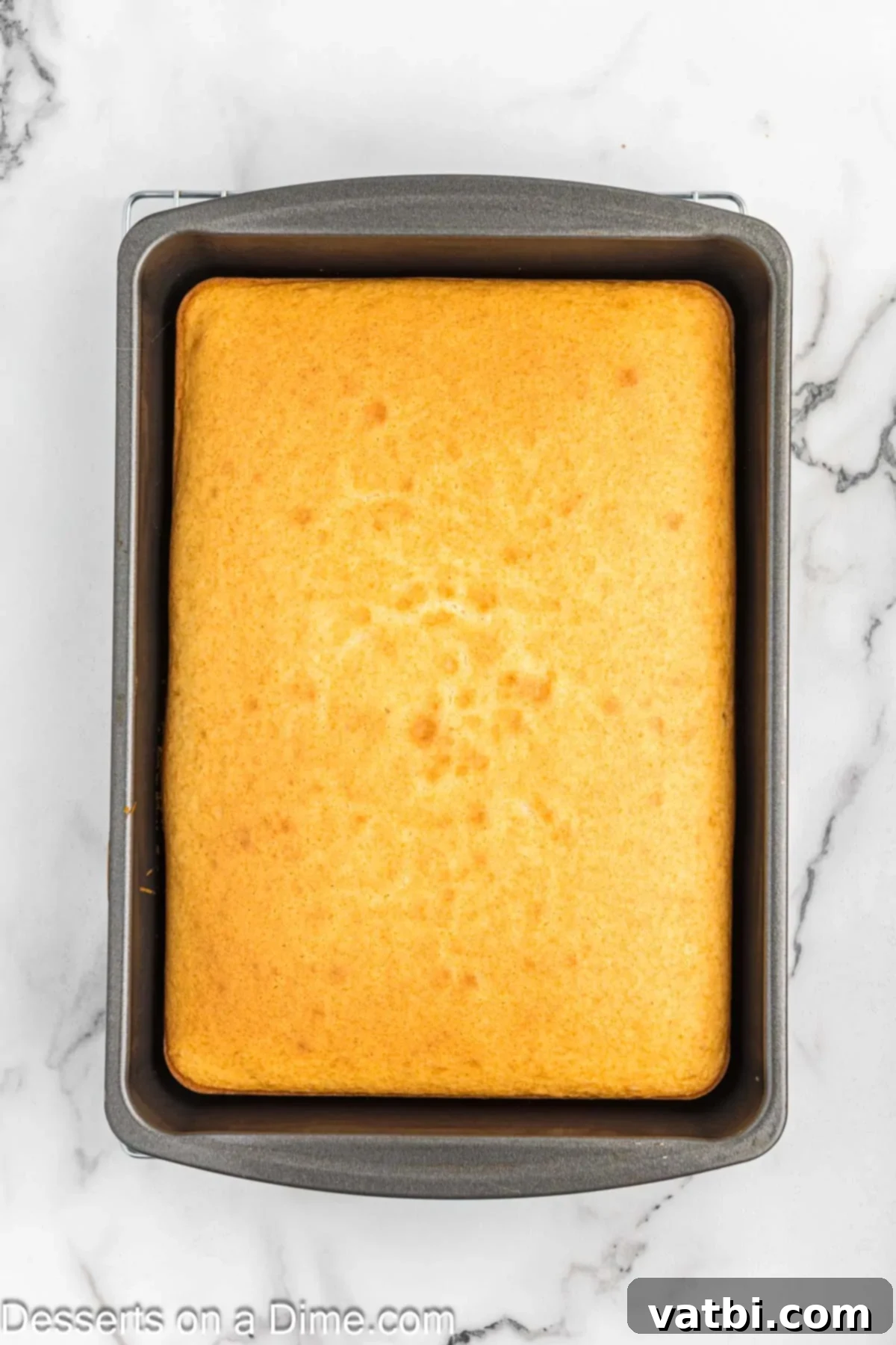 Delicious Homemade Cake Pops 4 Baked cake in 9x13 pan. A golden brown baked cake cooling in a 9x13 inch baking pan.