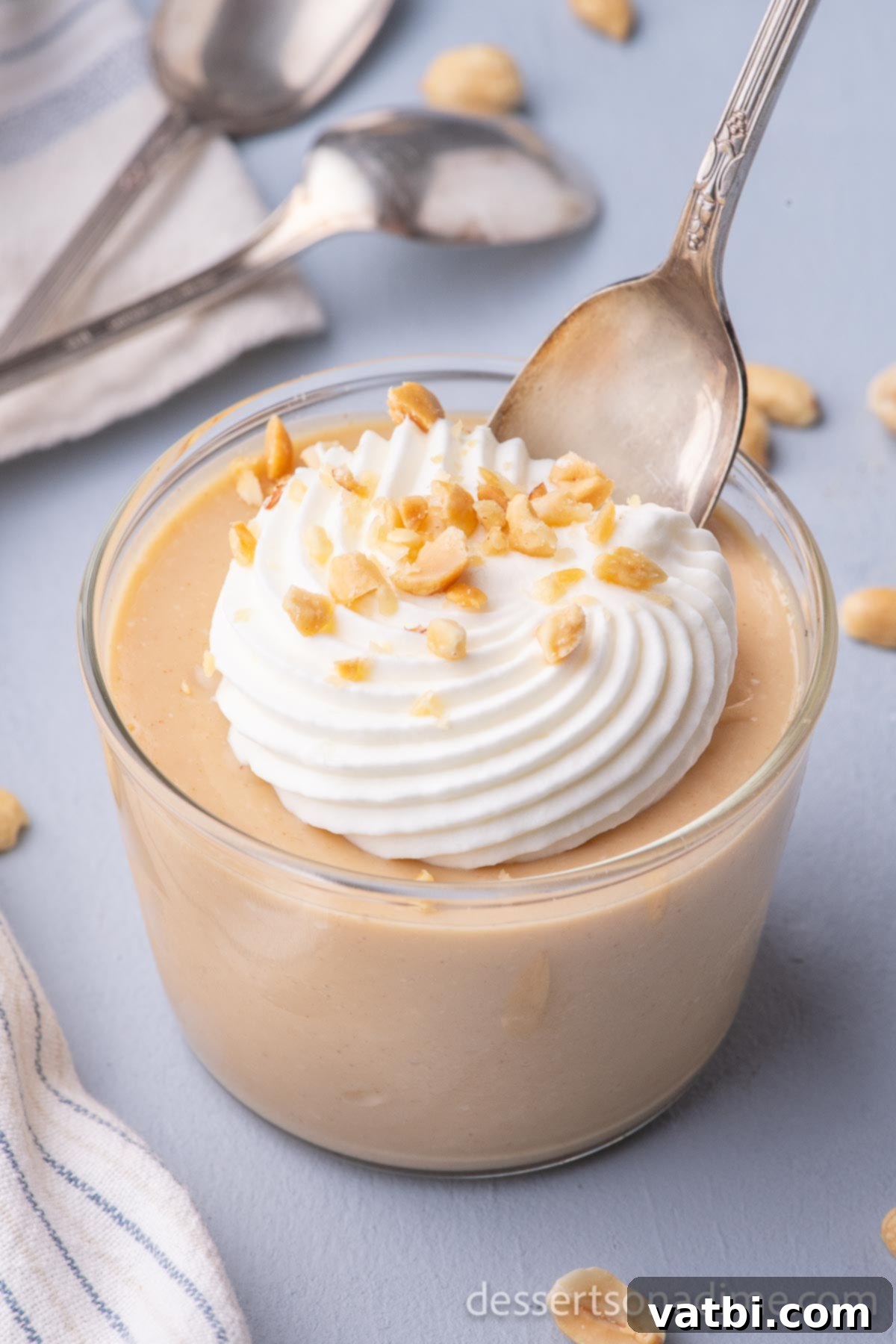 Creamy Peanut Butter Delight 2 Peanut Butter Pudding in a cup with whipped cream and chopped peanuts.