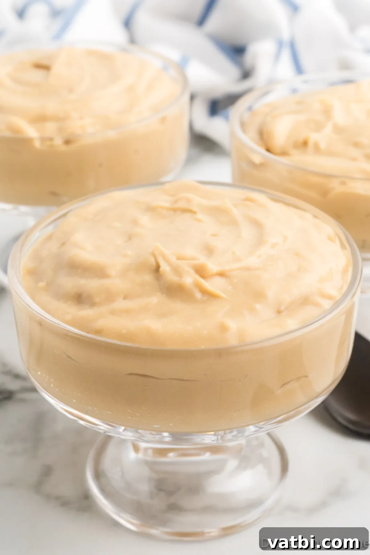 Creamy Butterscotch Bliss 2 Delightful homemade butterscotch pudding served in individual cups, ready to enjoy as a perfect creamy dessert.