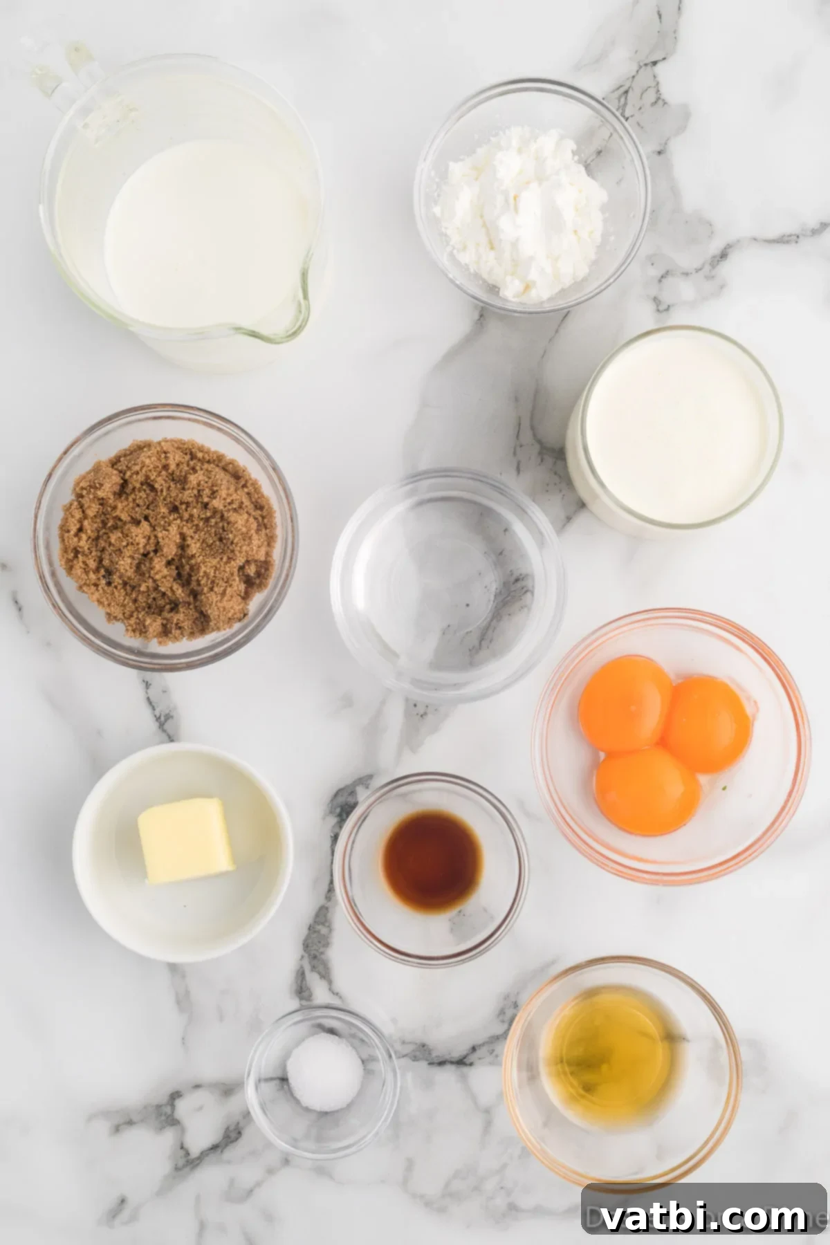 Creamy Butterscotch Bliss 3 Fresh ingredients laid out for making butterscotch pudding including dark brown sugar, cornstarch, milk, heavy cream, butter, egg yolks, vanilla extract, and optional bourbon.