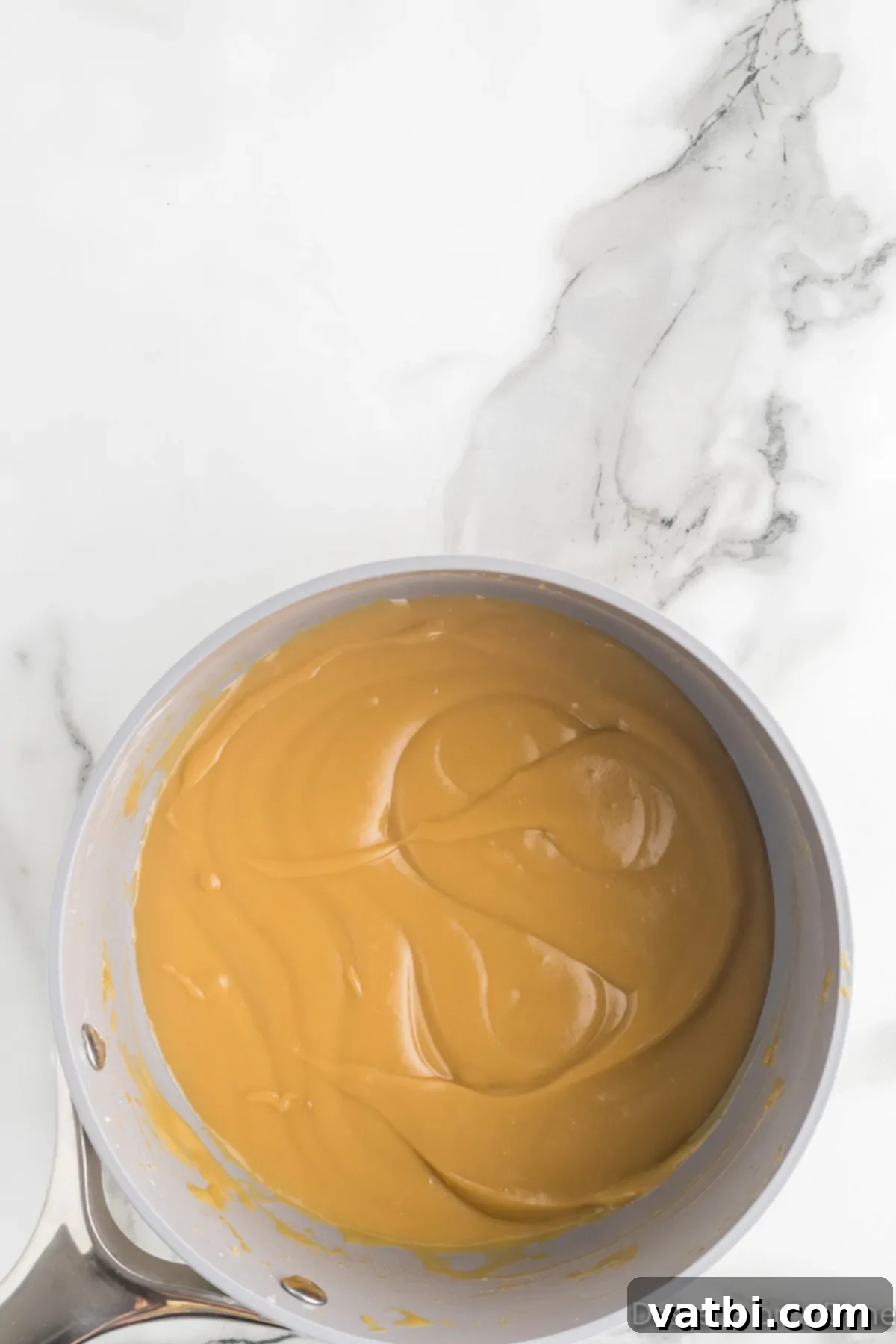 Creamy Butterscotch Bliss 9 Smooth butterscotch pudding poured into individual serving bowls, ready to cool and chill.