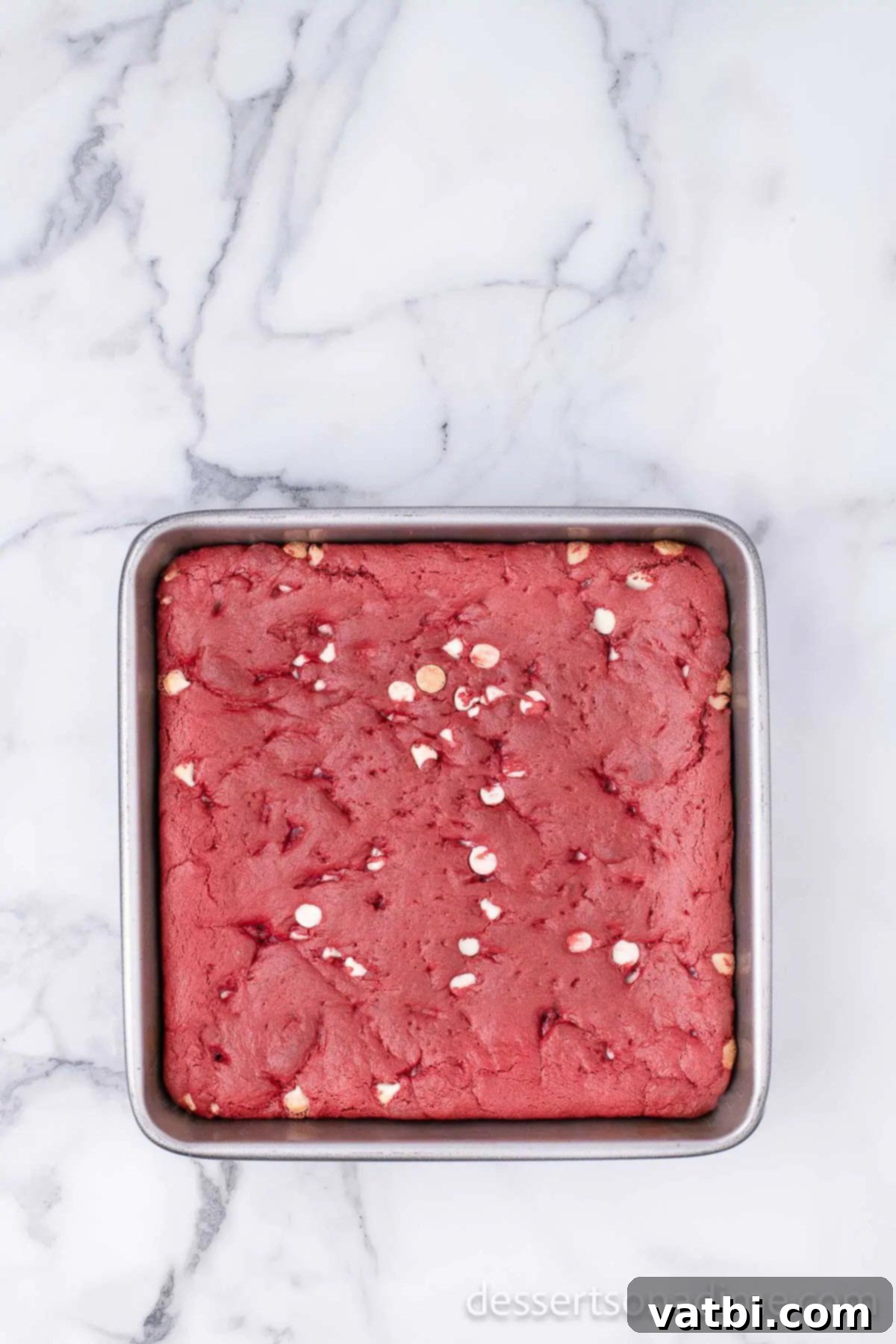 Velvet Red Brownie Bliss 5 A baked pan of red velvet brownies, cooling and ready to be sliced.