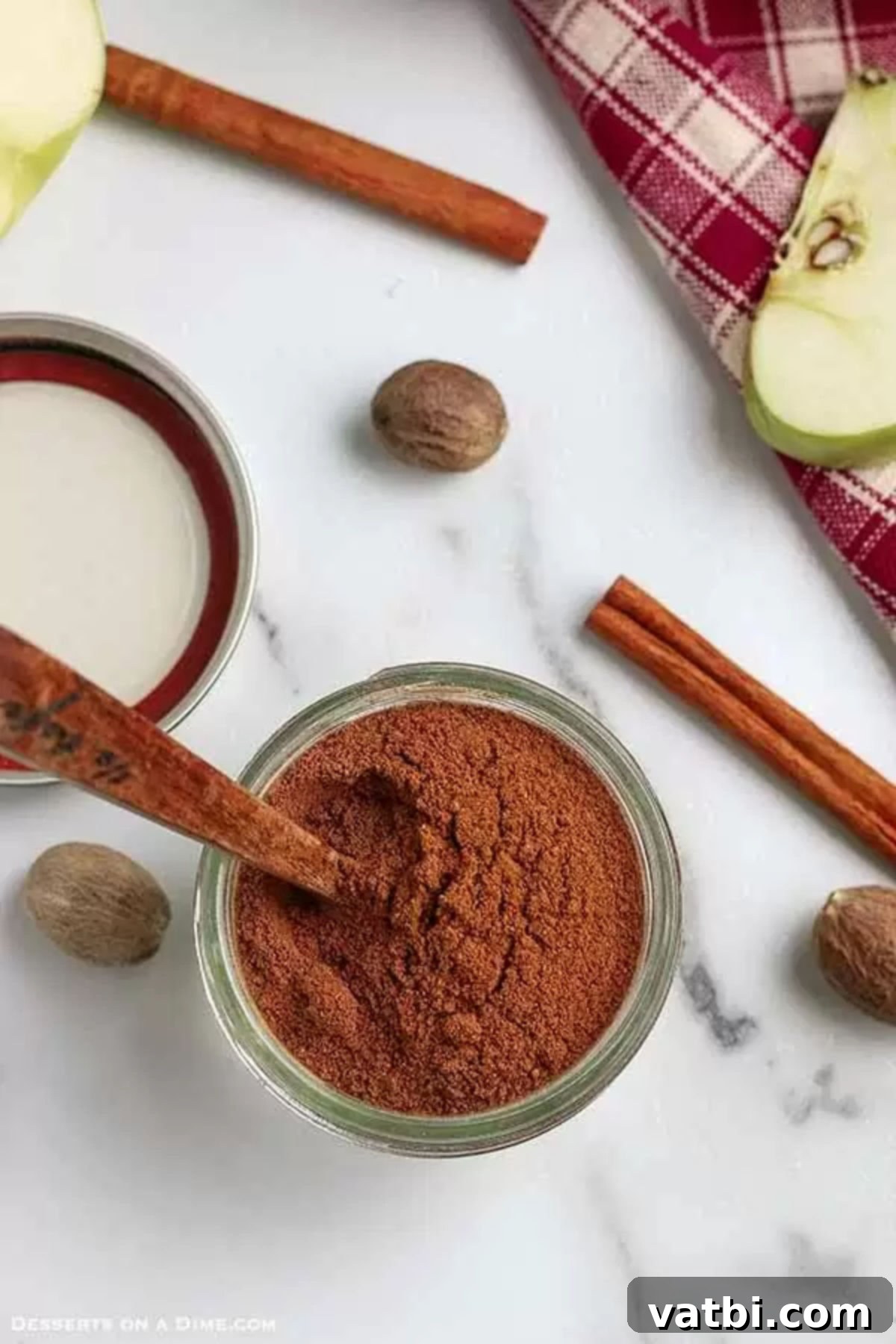 Learn how to make Apple pie spice mix recipe at home and save money. Homemade apple pie spice is so easy to make and only takes a few minutes. Try homemade apple pie spice mix recipe without cardamom today.#dessertonadime #applepiespicerecipe #homemade A charming glass jar filled with freshly made apple pie spice, ready for baking.