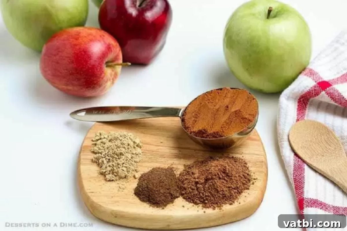 Learn how to make Apple pie spice mix recipe at home at home and save money. Homemade apple pie spice is so easy to make and only takes a few minutes. Try homemade apple pie spice mix recipe without cardamom today.#dessertonadime #applepiespicerecipe #homemade Individual bowls of ground cinnamon, nutmeg, allspice, and ginger, arranged with a measuring spoon.