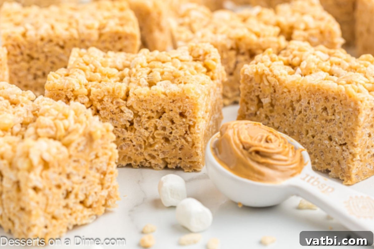 Chewy Peanut Butter Rice Krispie Treats 2 Squares of Peanut Butter Rice Krispie treats with a scoop of peanut butter on the side.