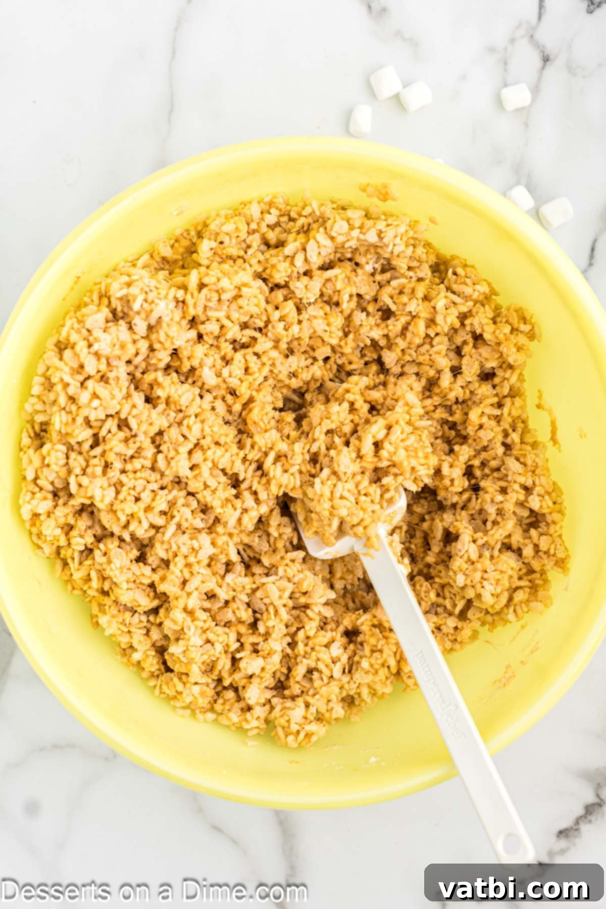 Chewy Peanut Butter Rice Krispie Treats 5 Crispy rice cereal being added to the melted peanut butter marshmallow mixture.