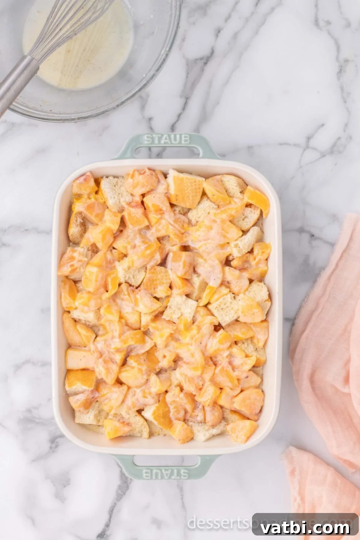 Golden Peach Bread Pudding 8 The bread and peach custard mixture spread into the baking dish, ready for soaking.