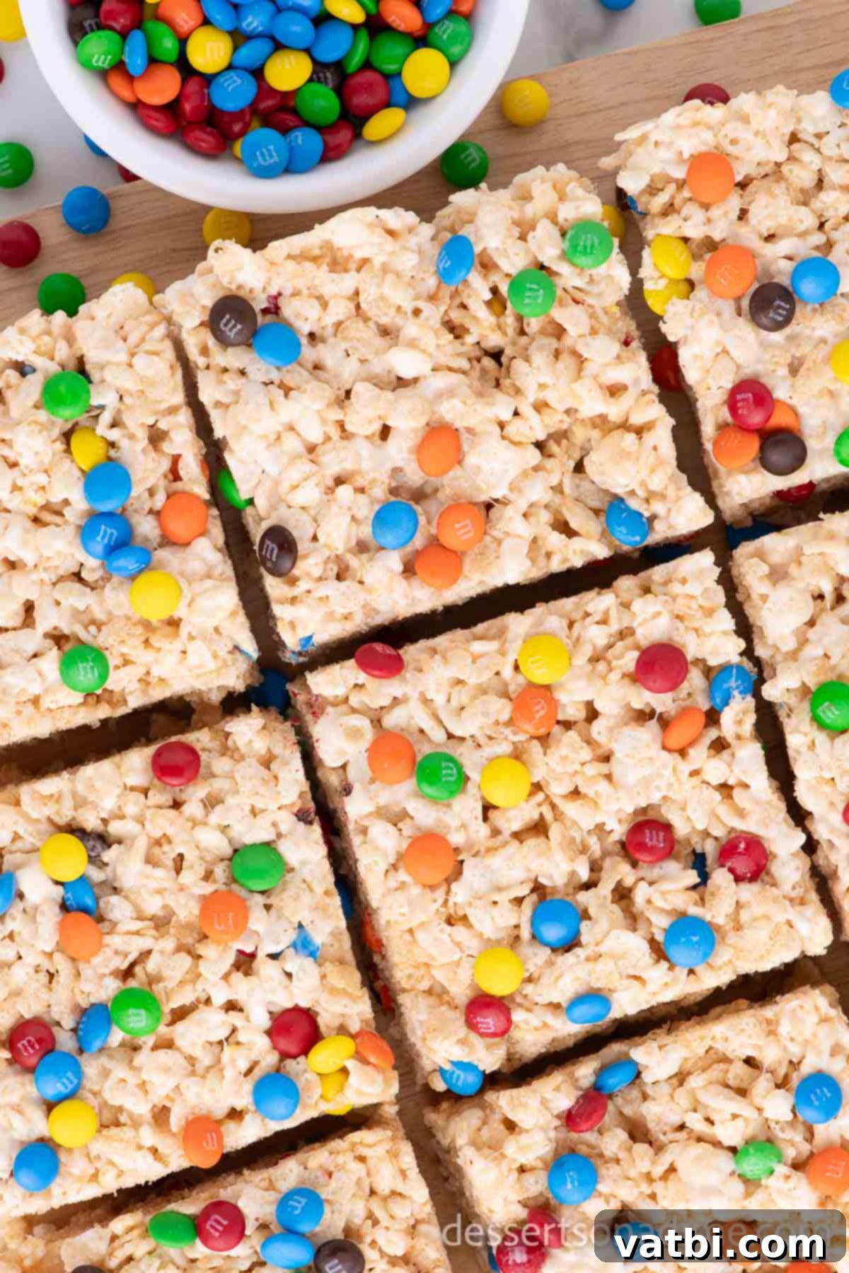 Rainbow Chocolate Krispie Squares 2 M&M Rice Krispy Treats cut into squares, showcasing colorful M&M candies.