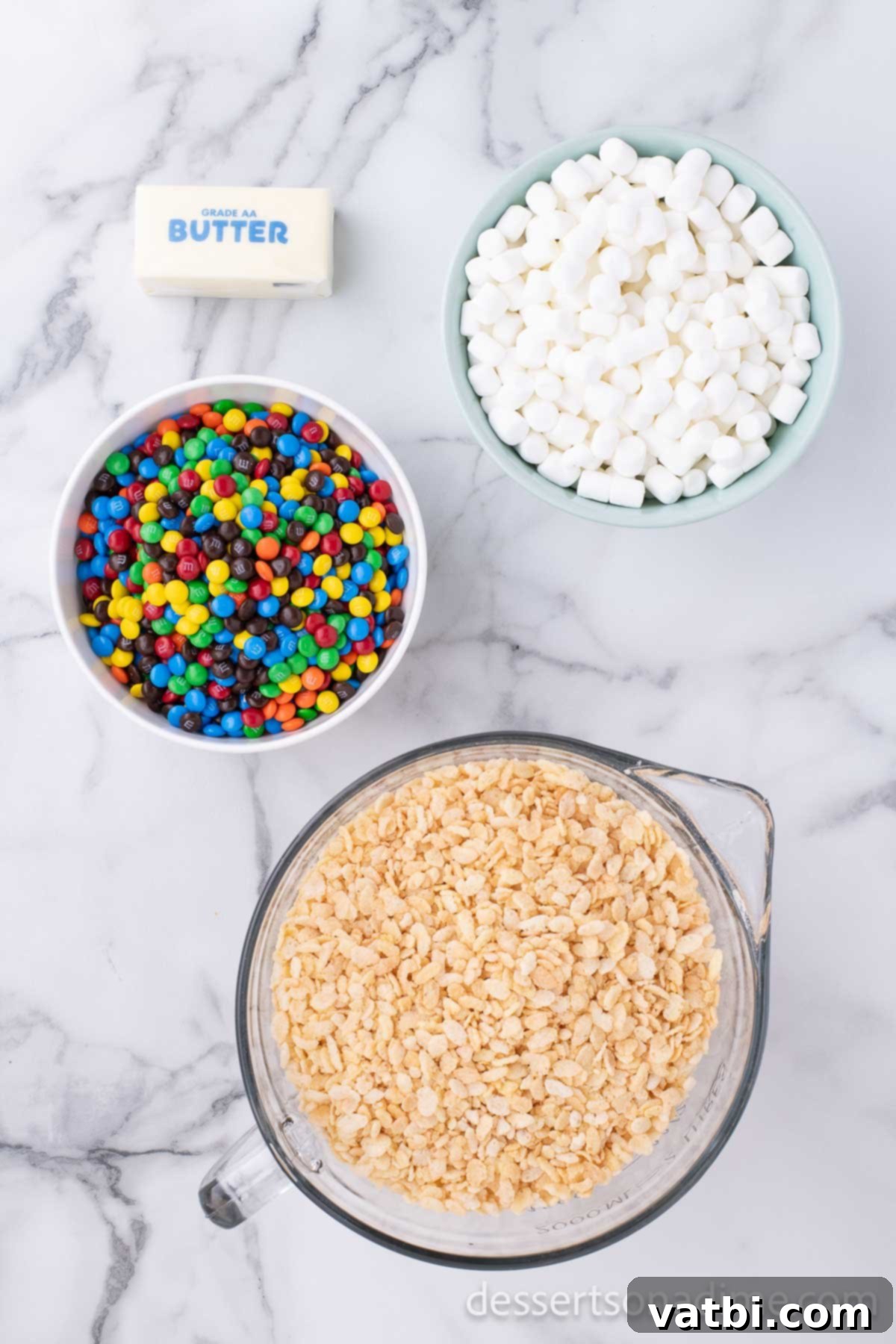 Rainbow Chocolate Krispie Squares 3 Ingredients for M&M rice krispy treats - rice cereal, salted butter, marshmallows and mini M&Ms.