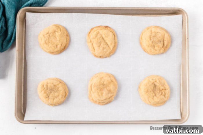 Brown Sugar Cookies 5 Brown sugar cookies baking on a parchment-lined baking sheet.
