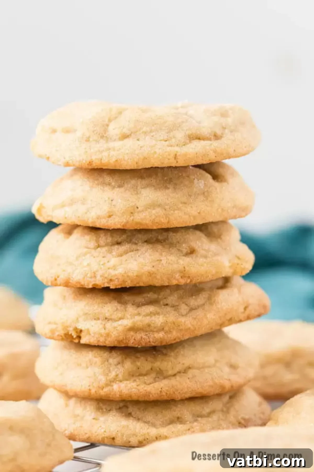You probably already have what you need to make this easy Brown sugar cookie recipe. These cookies are soft and chewy and simply amazing. Learn how to make the best homemade brown sugar cookies recipe. This cookie dough is simple and perfect for Christmas. #dessertonadime #BrownSugarCookies #RecipeEasy #cinnamon #lightf #simple Stack of golden brown sugar cookies on a white plate, ready to be enjoyed.