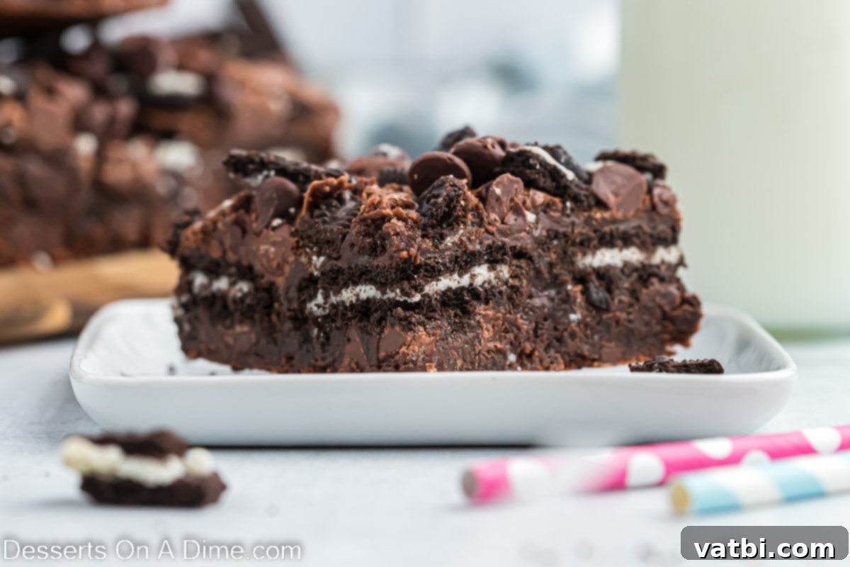 Decadent Oreo Brownies 2 Deliciously fudgy Oreo Brownies, cut into neat bars and arranged on a pristine white plate, showcasing their rich chocolate color and cookie chunks.