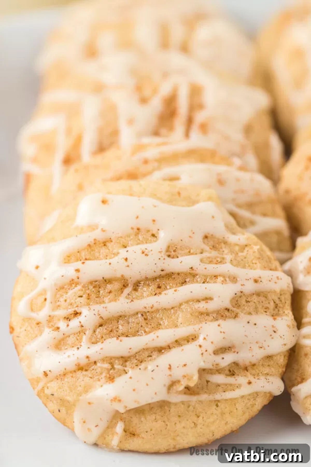 Delicious frosted eggnog cookies, soft and chewy, perfect for holiday parties. A stack of perfectly baked and frosted eggnog cookies, ready to be enjoyed.
