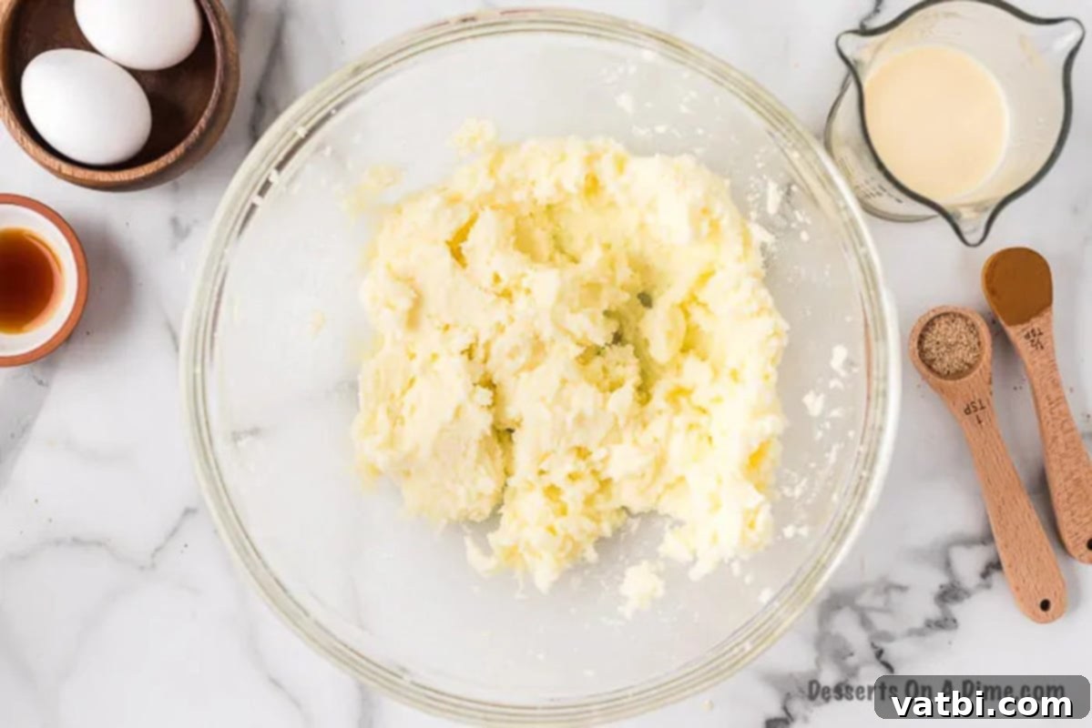 Festive Eggnog Cookies 2 Softened butter and white sugar being creamed together in a mixing bowl.