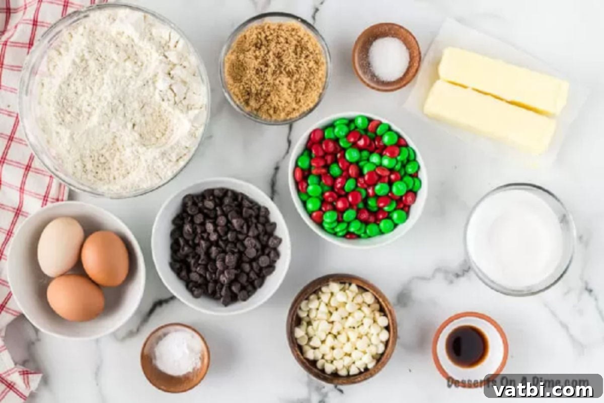 This easy Santa cookies recipe is sure to be a hit with lots of chocolate. These are the best cookies for Santa's plate and so simple. M&M Christmas Cookies are so easy to make for Christmas and combine chocolate chip and M&M candy. This is the perfect cookie for kids to put on Santa's platter. #dessertonadime #santacookiesrecipe #baking #kids Ingredients needed - flour, salt, baking soda, butter, brown sugar, sugar, vanilla, eggs, chocolate chips, M&M's