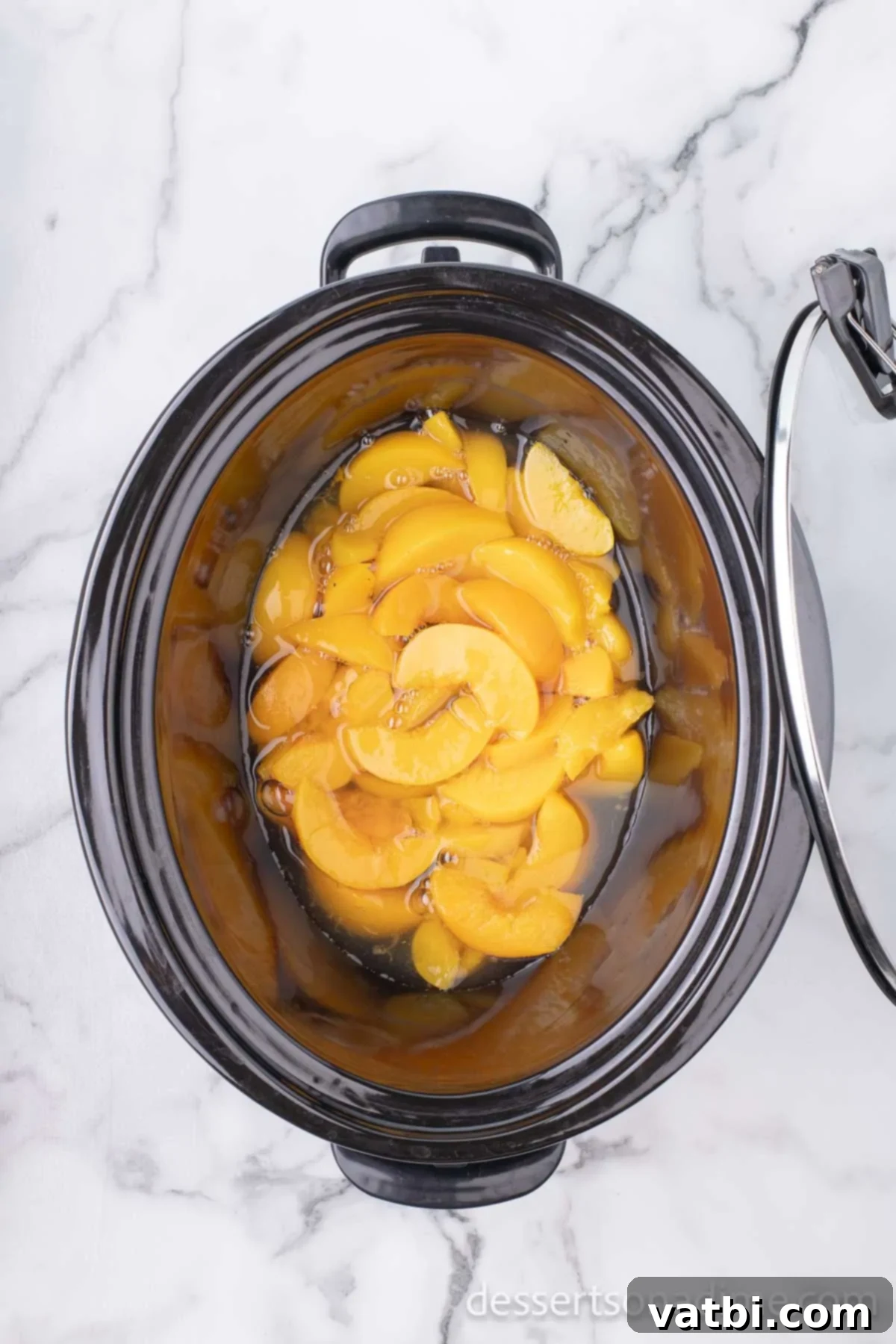 Effortless Slow Cooker Peach Delight 4 Peaches in slow cooker.