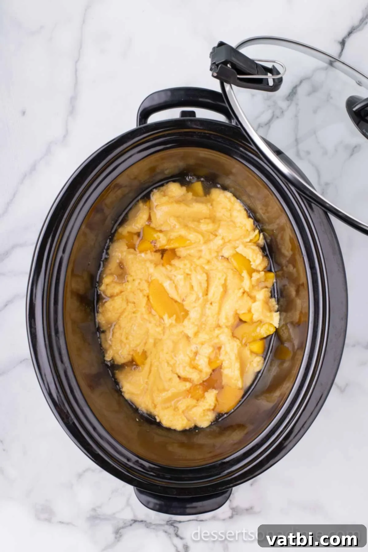 Effortless Slow Cooker Peach Delight 7 Cake mix on top of fruit.