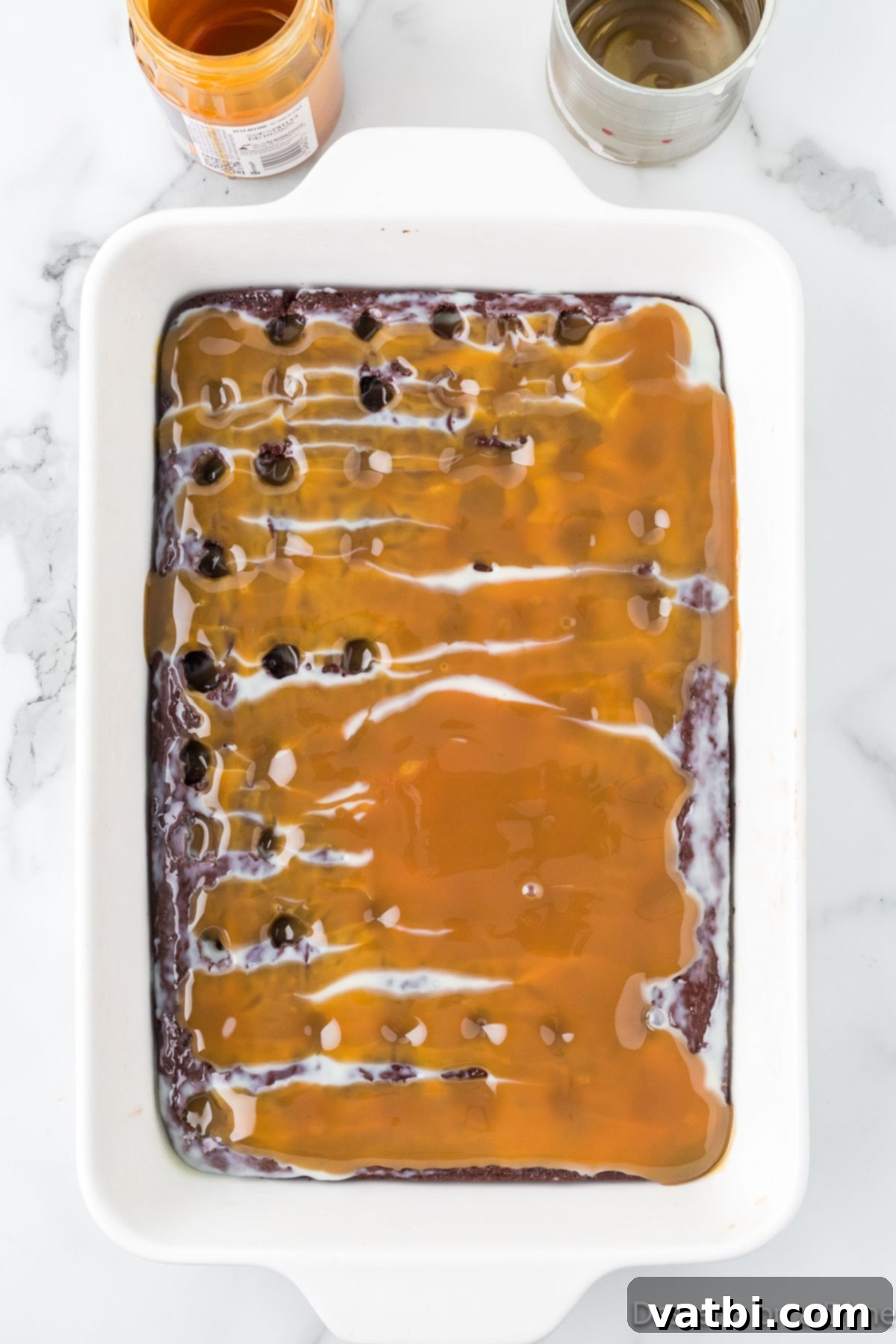 Liquid Gold Chocolate Poke Cake 6 Caramel spread over cake.