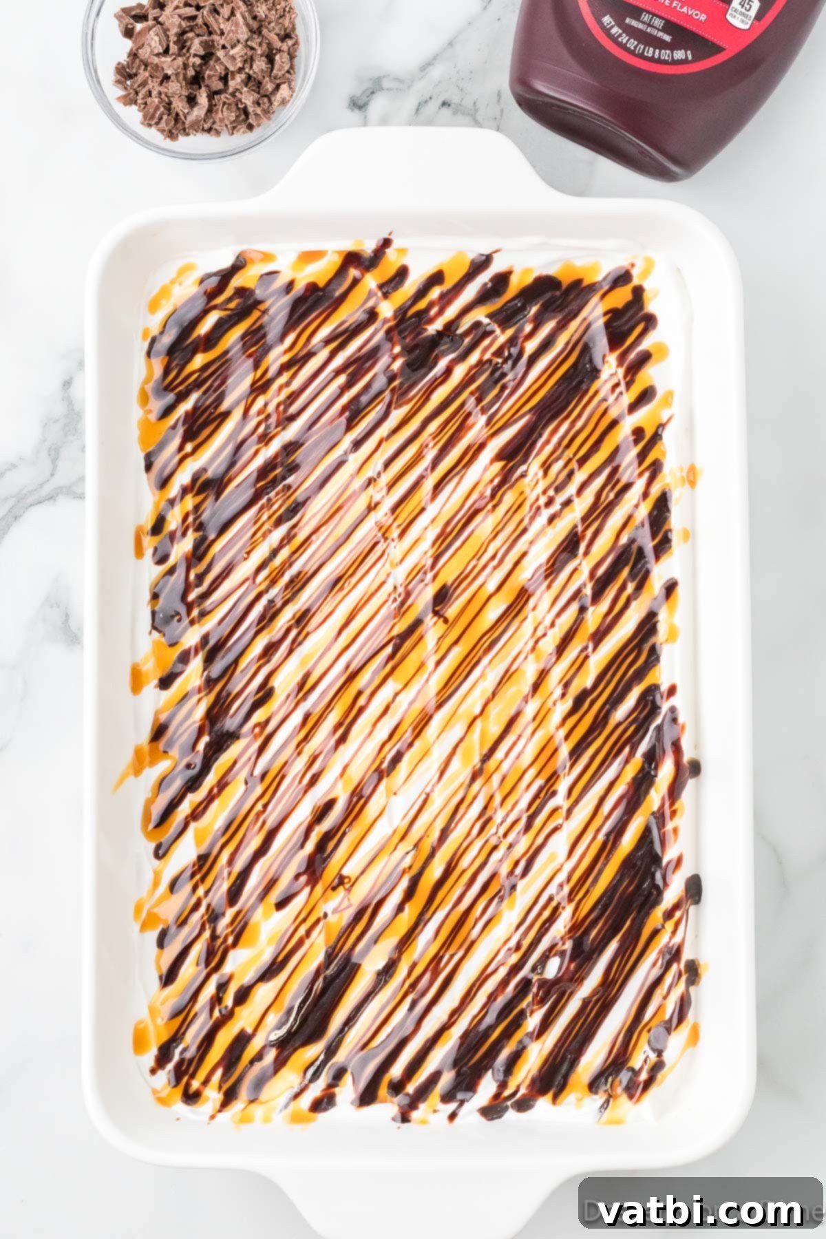 Liquid Gold Chocolate Poke Cake 8 Chocolate and caramel swirled on top of cake.