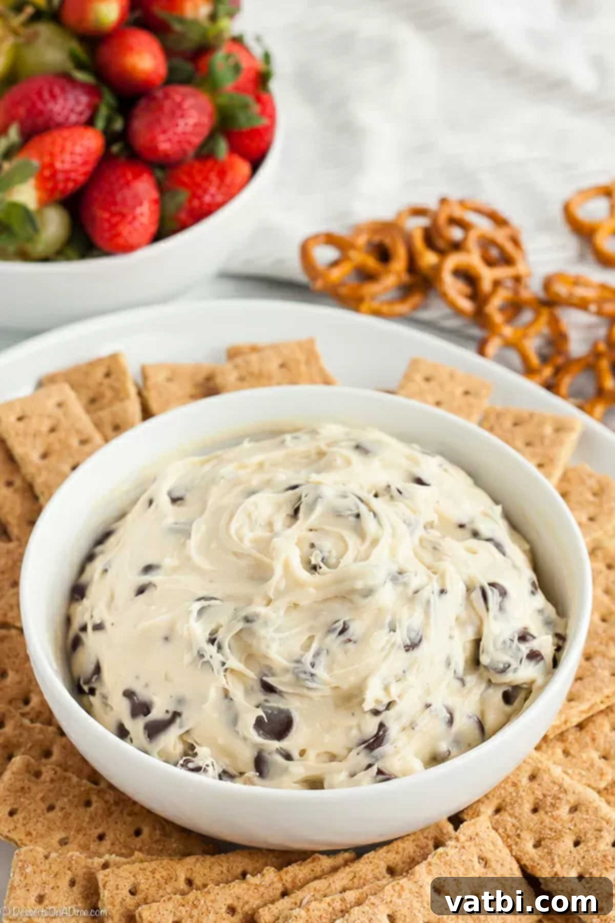 Chocolate Chip Cookie Dough Dip Recipe is super easy to make. This recipe is full of chocolate chips and a creamy mixture for a dip you can't resist. A bowl of creamy chocolate chip cookie dough dip, ready to be served.